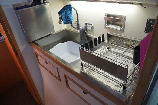 A sink and faucet in a kitchen
AI-generated content may be incorrect.