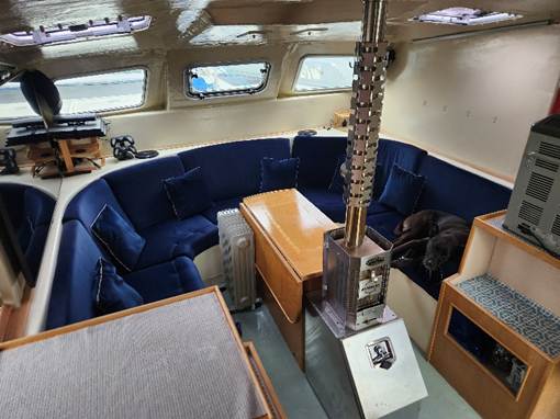 A dog sleeping on a couch in a boat
AI-generated content may be incorrect.